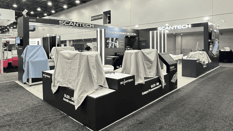 Clean energy product demo booth with screen displays, sample counters, and organized staff access