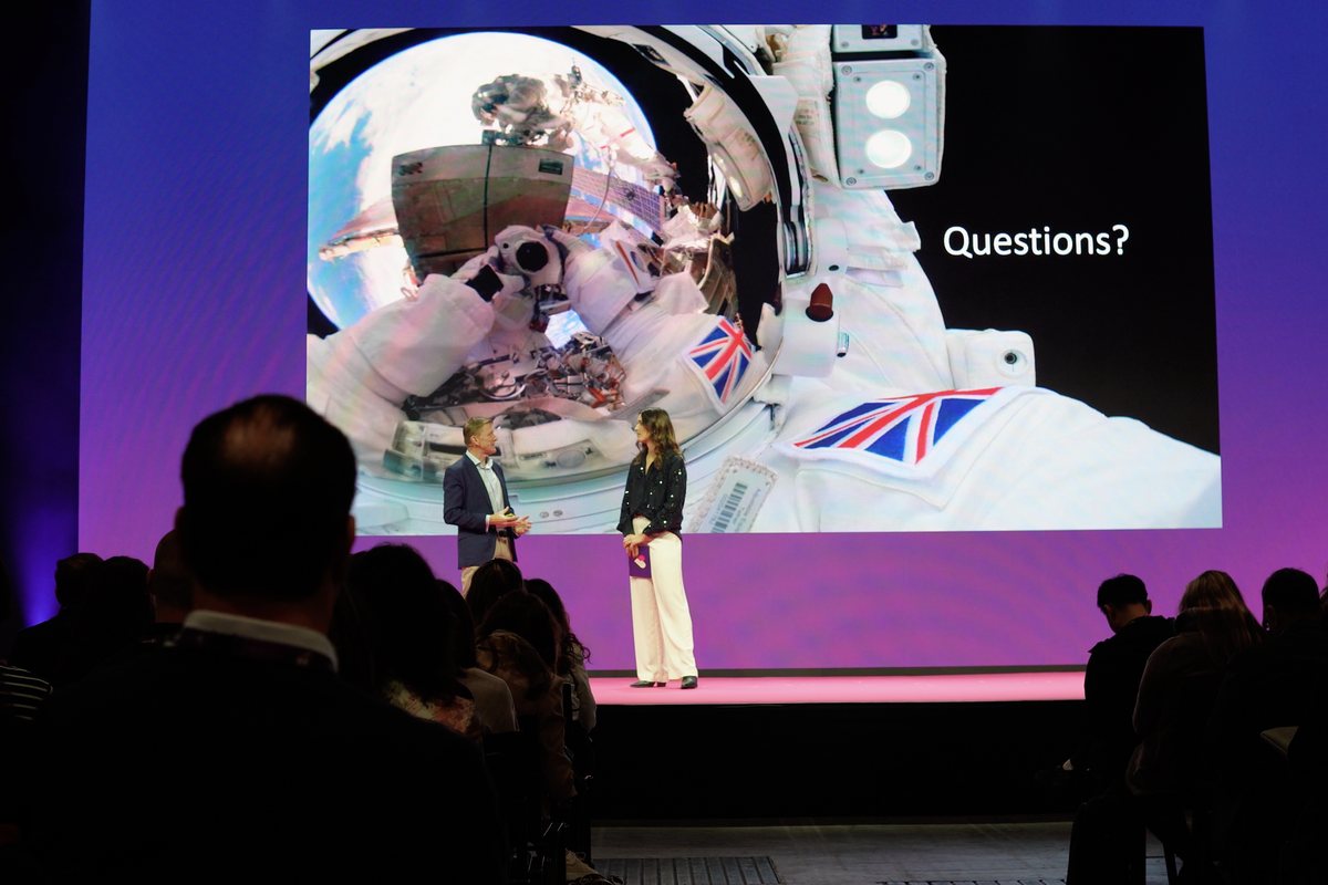 Shannon Jenkins interviewing a guest on stage