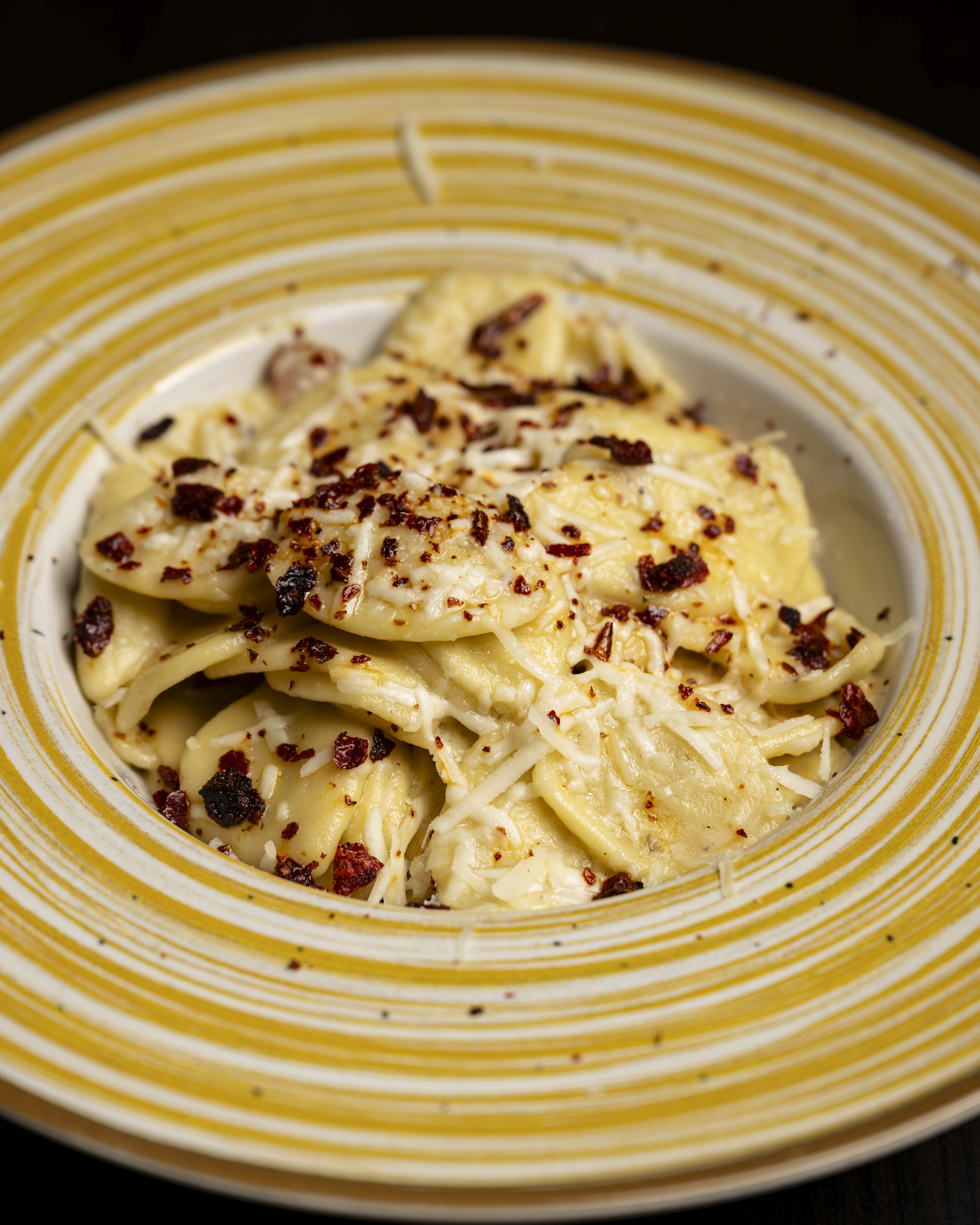 Restaurant exterior with black facade and welcoming atmosphere.