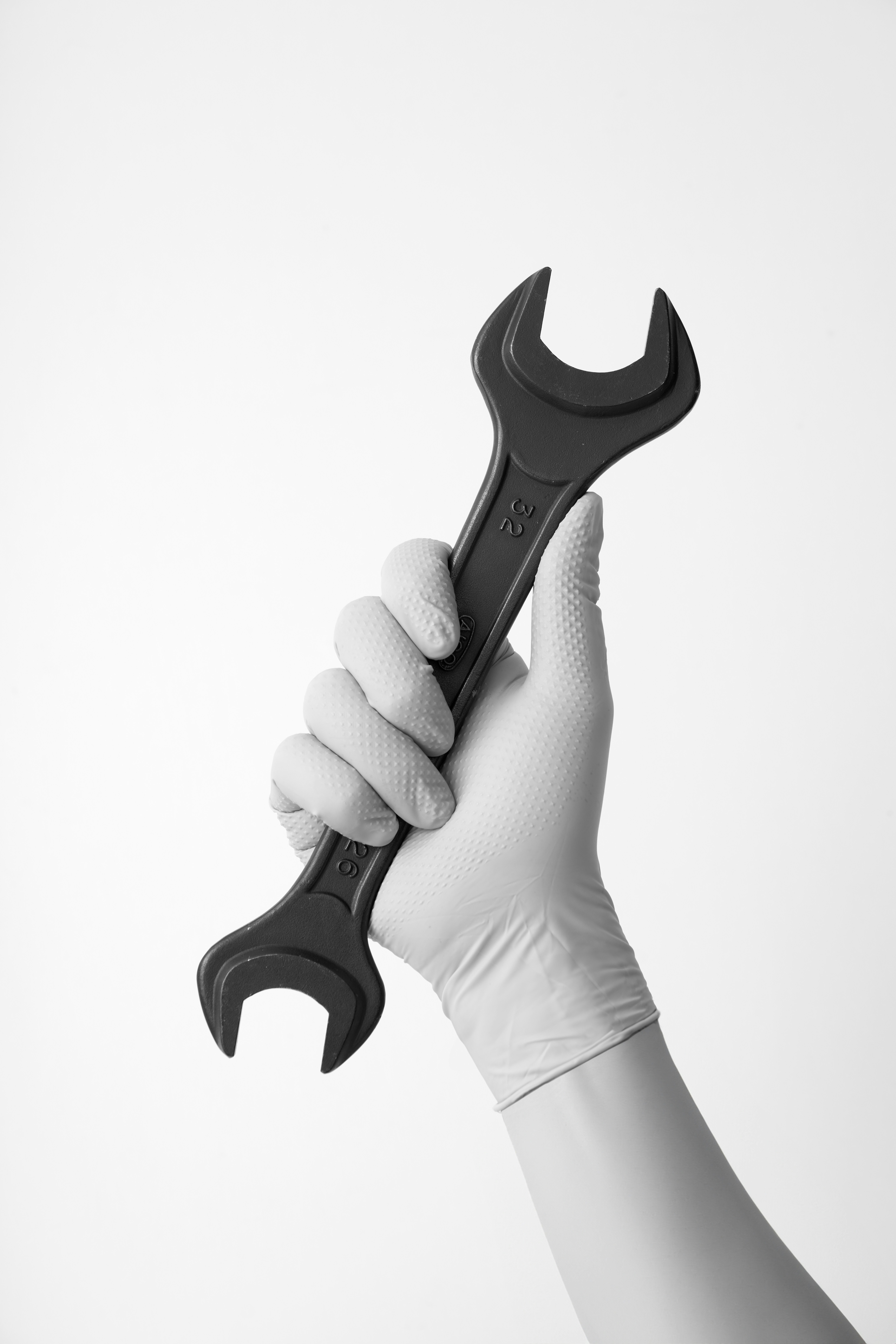 A person holding a wrench in their hand