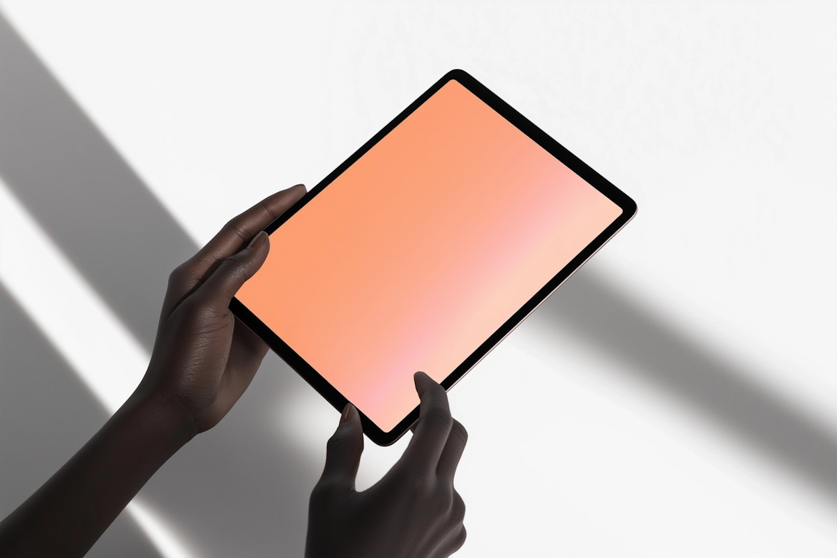 A cat laying on a desk next to a computer