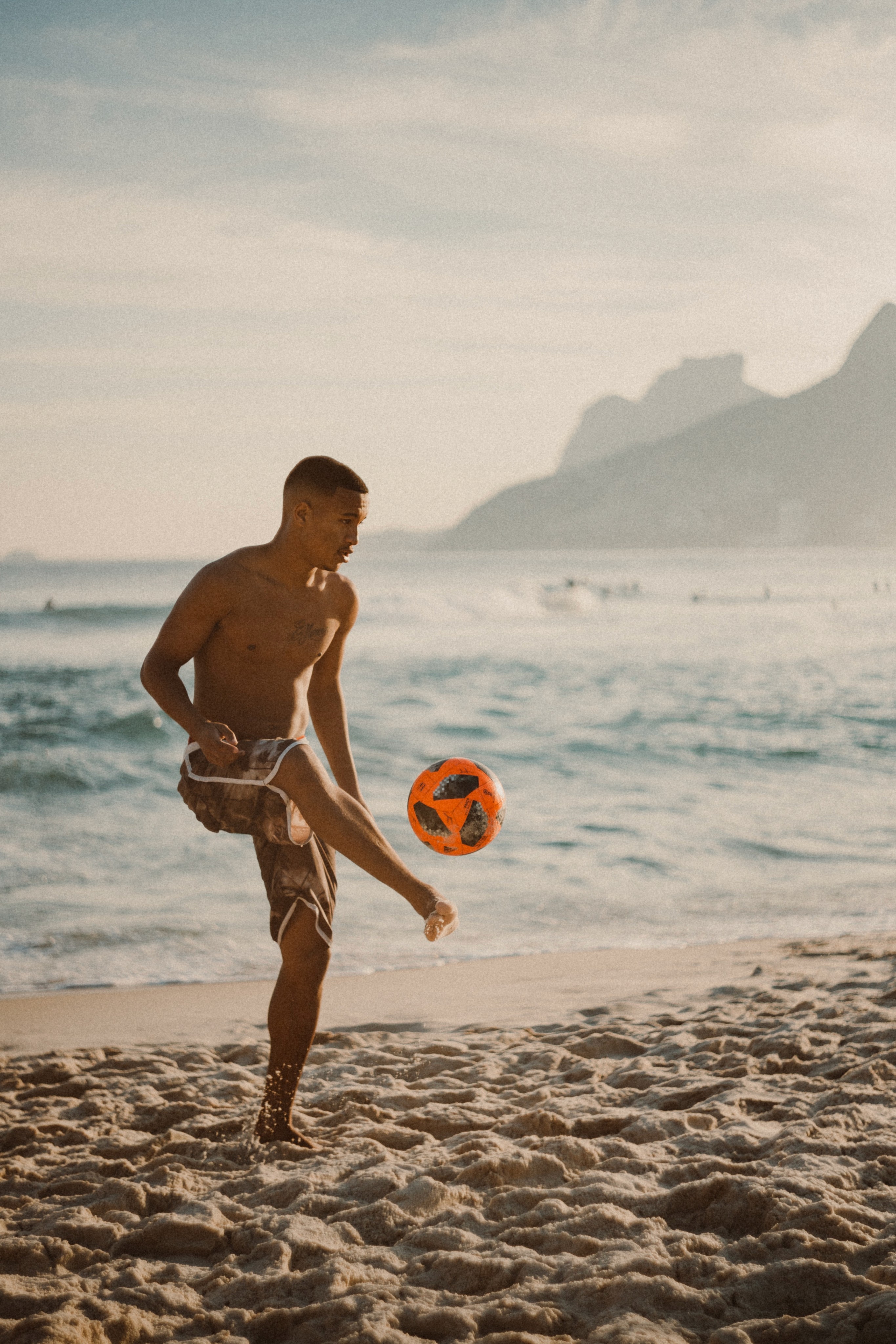 Man playing football on one of Rio's beaches.