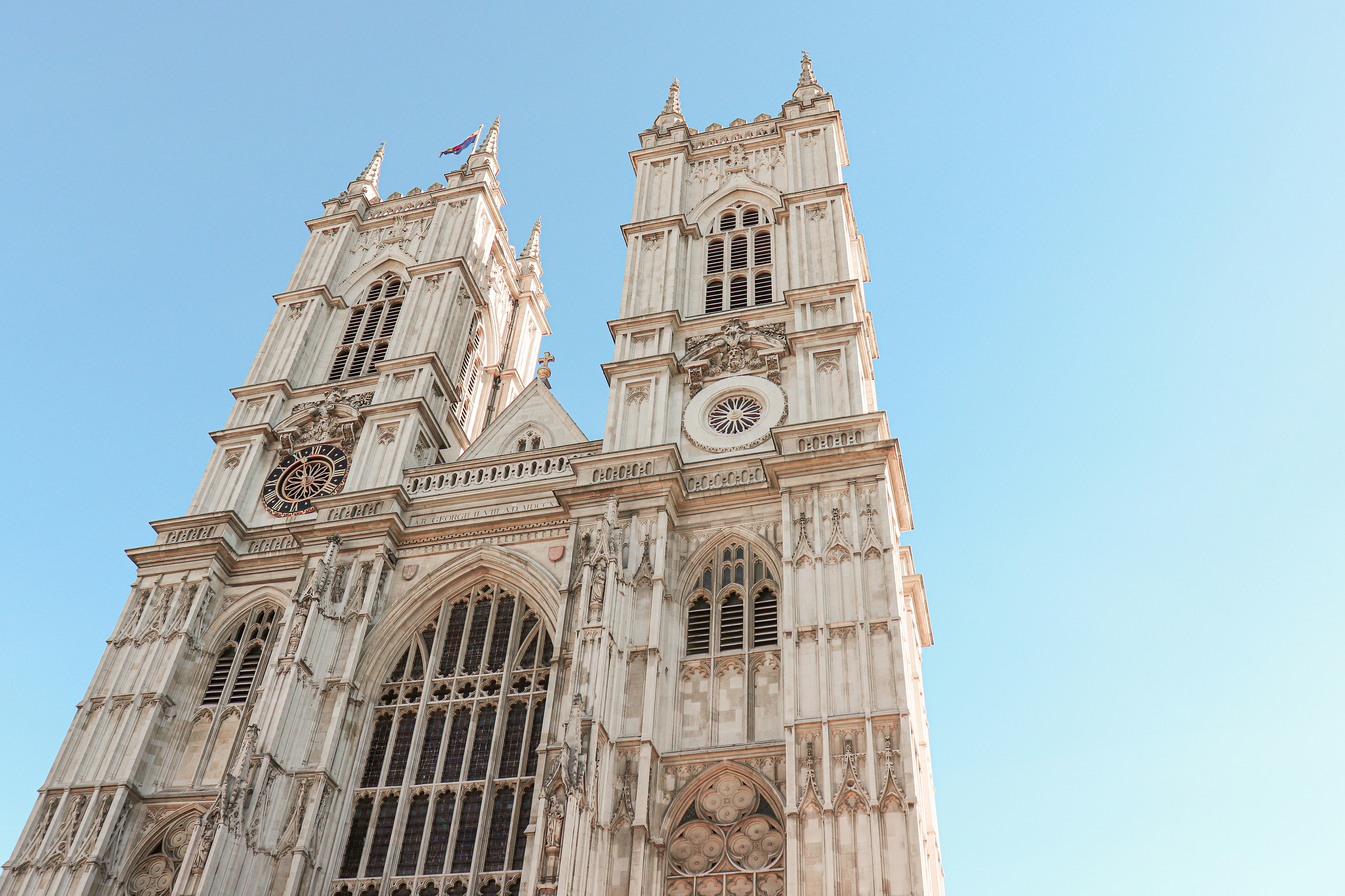 One of the towers of Westminster Abbey church, with a blue sky behind it.