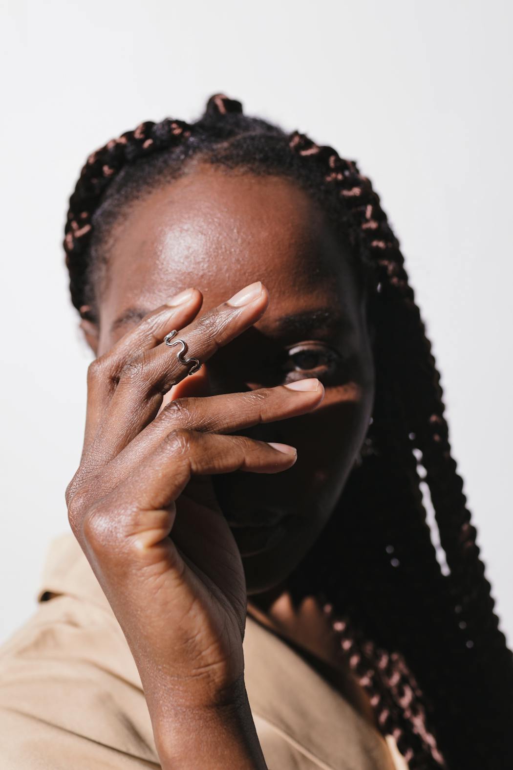 Portrait of a woman hiding her face with one hand