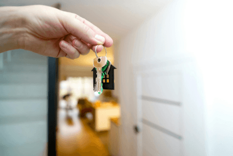 A collection of various coins scattered on a wooden surface.