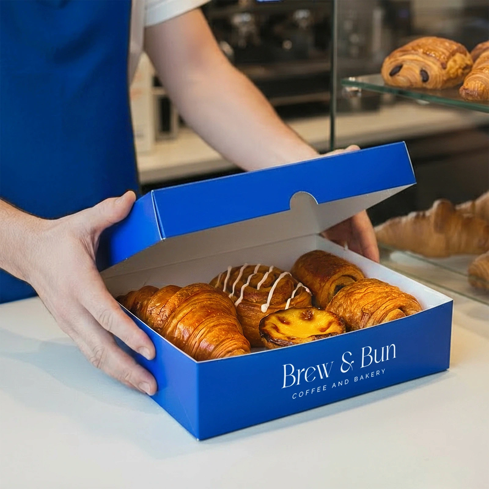 Box branded Brew & Bun full of patries
