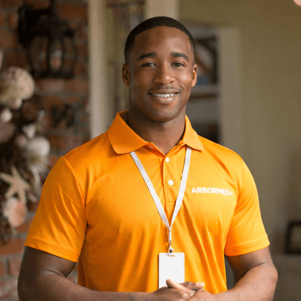 a man in a yellow shirt is working on a roof