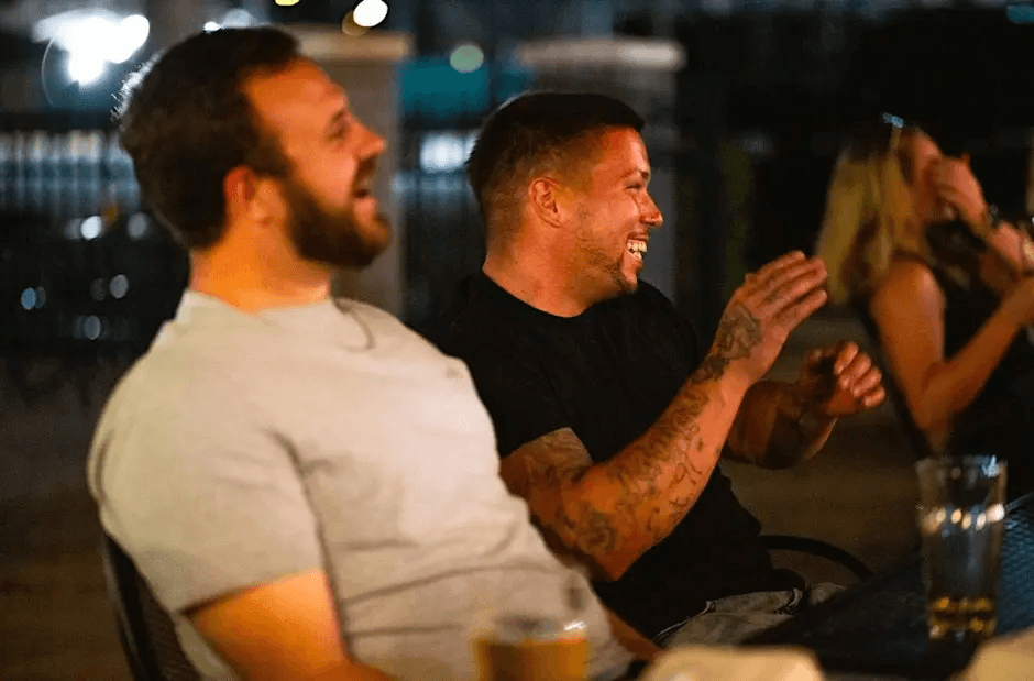 Friends Laughing and Clapping at a Comedy Show in St Pete