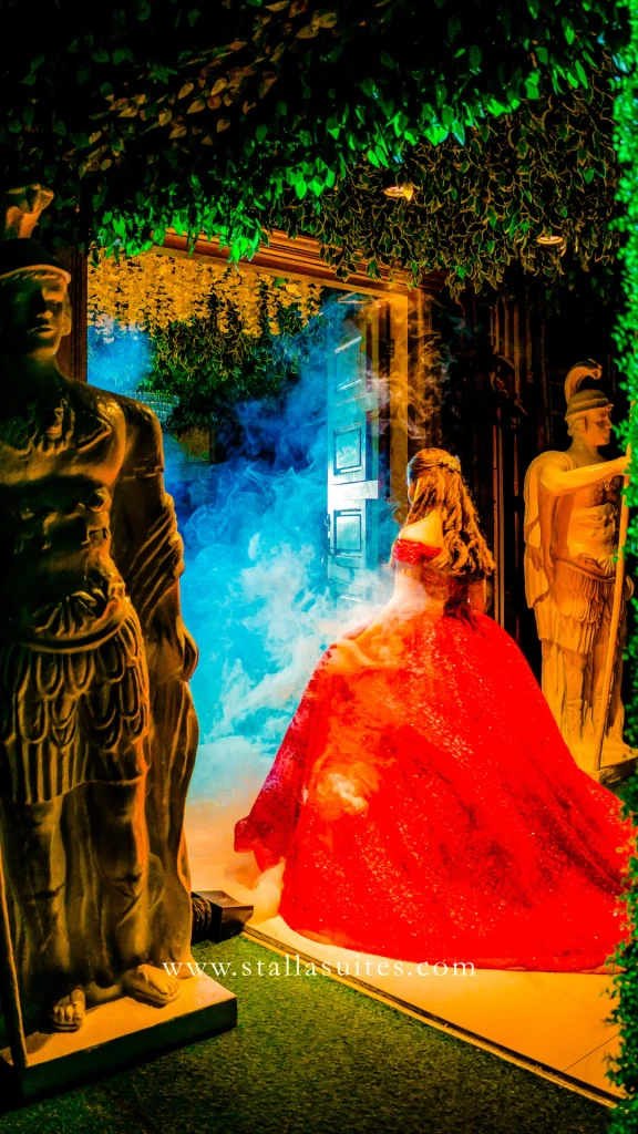 Debutante in red between the statues of Pandora Hall in dramatic light