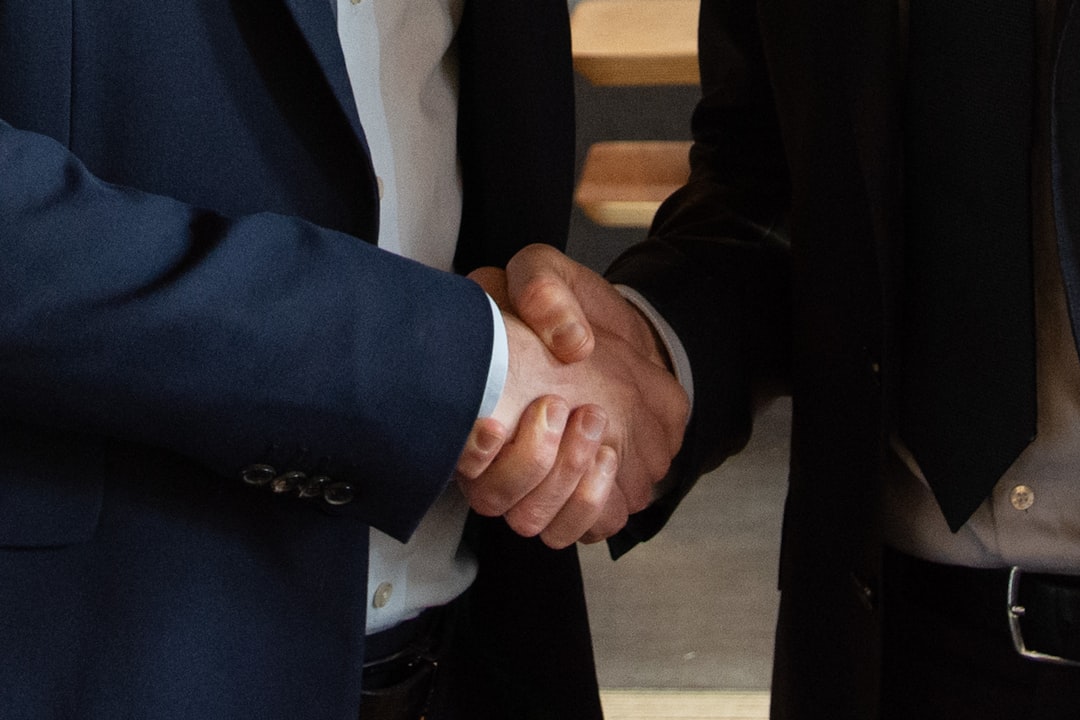 two business leaders shaking hands on a deal - business growth strategies