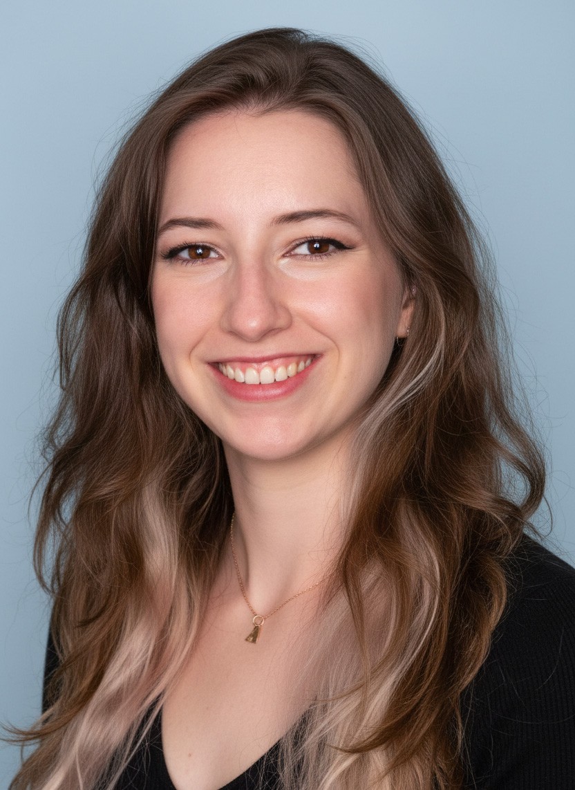 A thoughtful young person with dark hair gazes to the side, captured in soft black and white lighting.