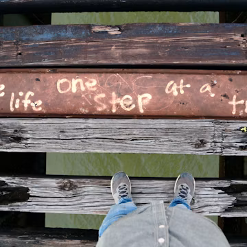 a person with their feet up on a bench