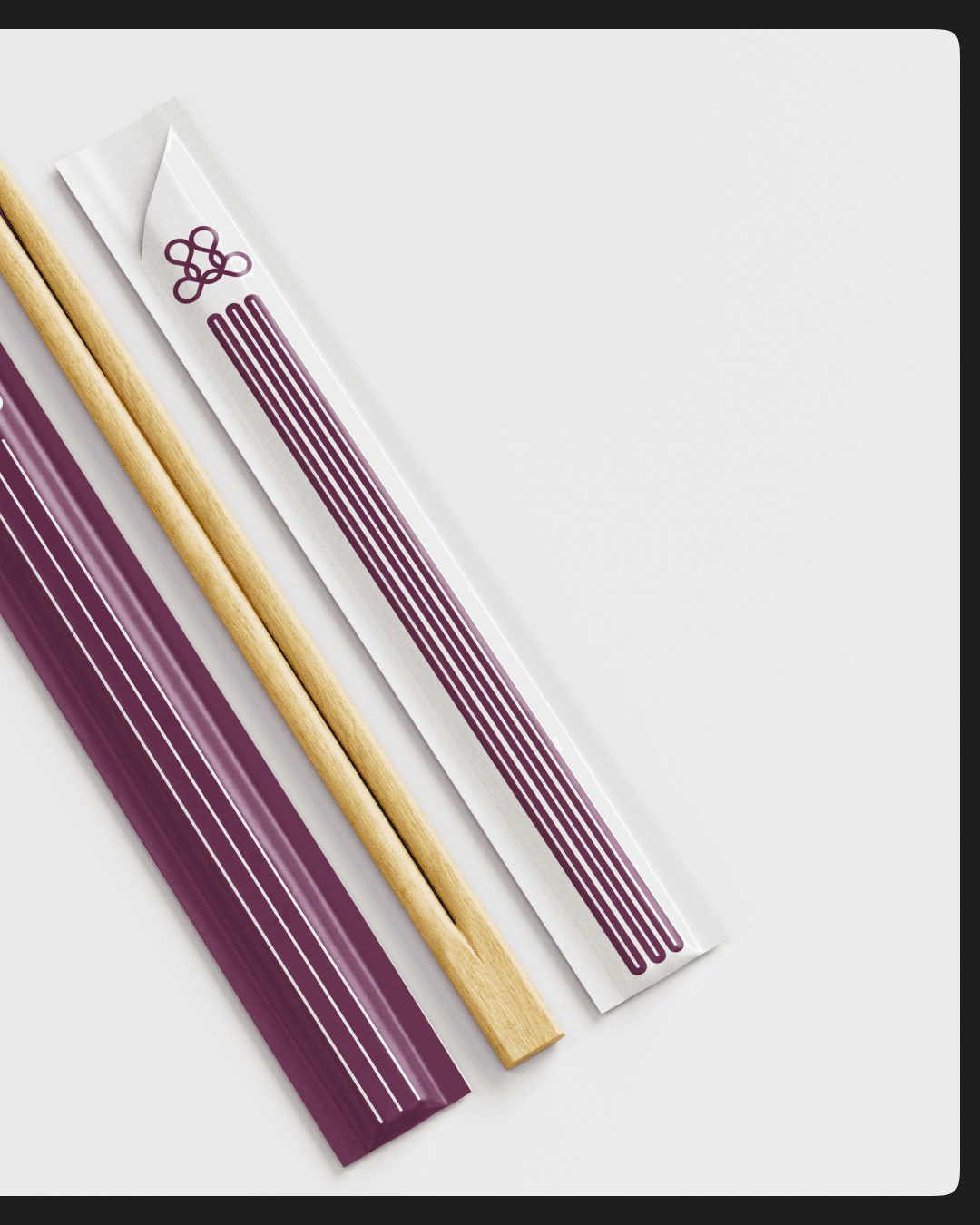 Modern architectural workspace with large floor-to-ceiling windows, surrounded by trees, and desks filled with design materials and books. Two blurred figures are walking through the space.