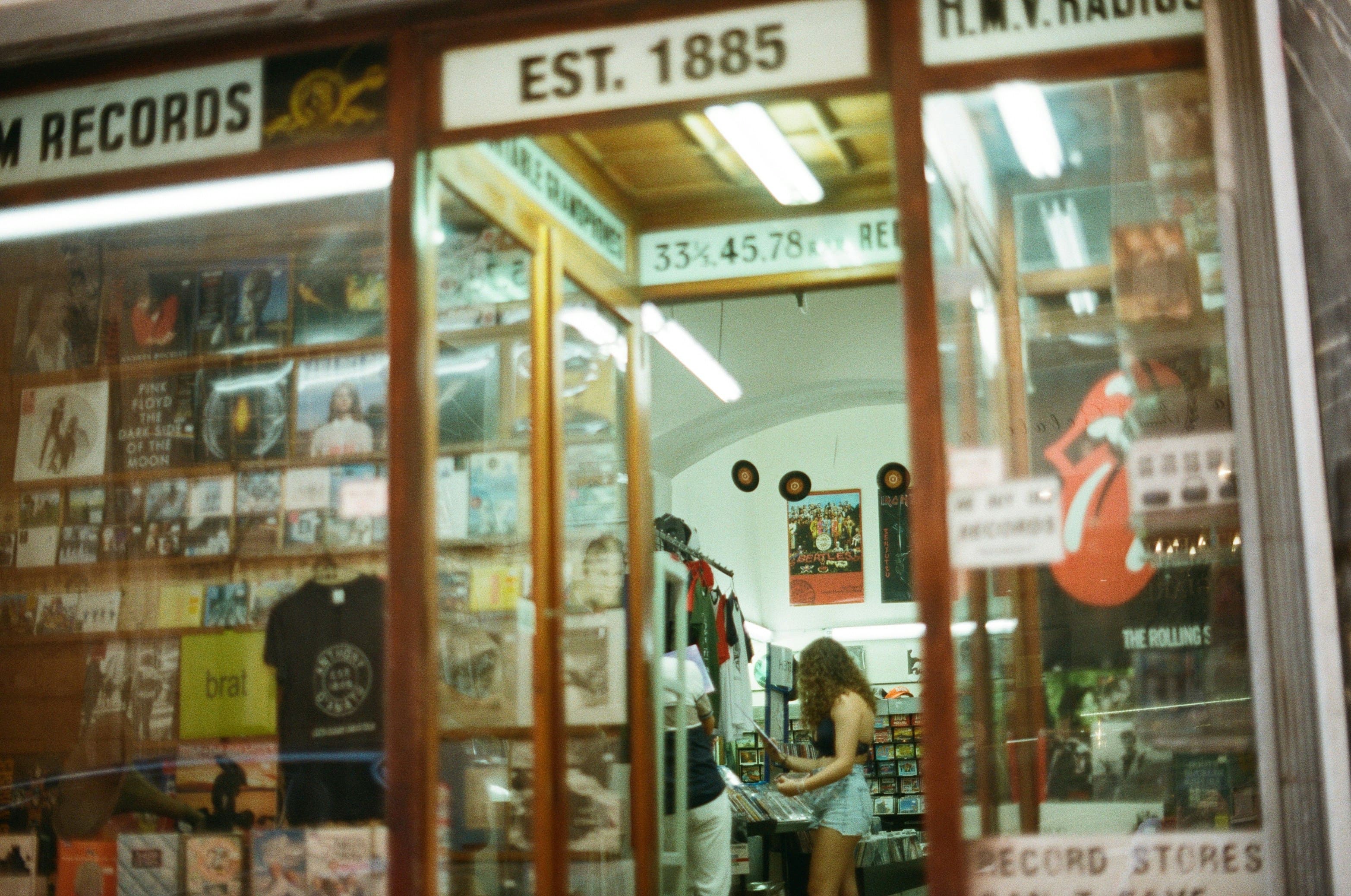 Inside a vintage record store with vinyl records displayed and a customer browsing through crates