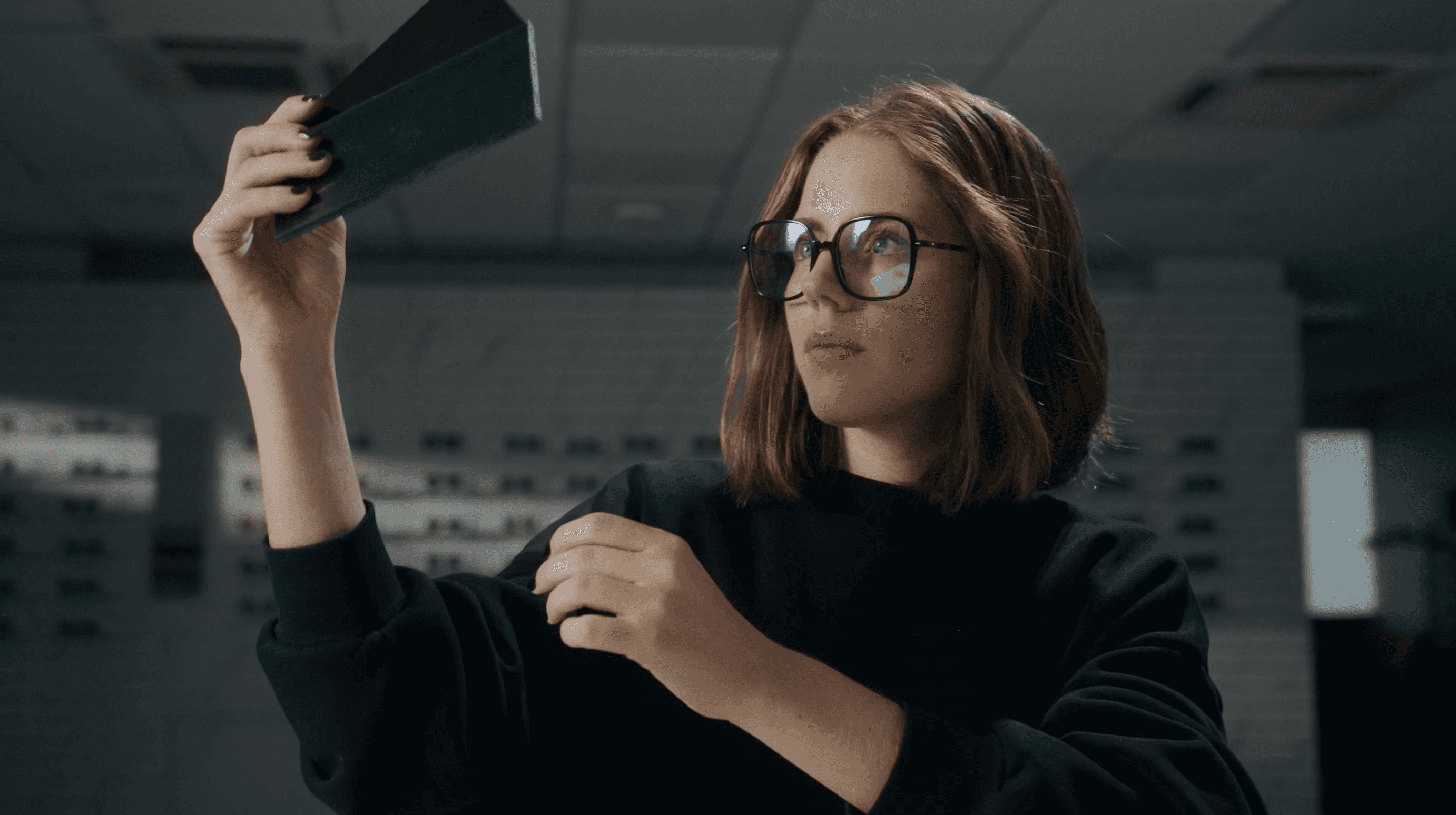 Product designer analyzing prototype component in modern technology laboratory