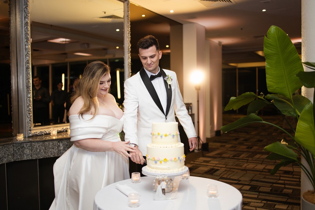 Bride and groom cutting cake