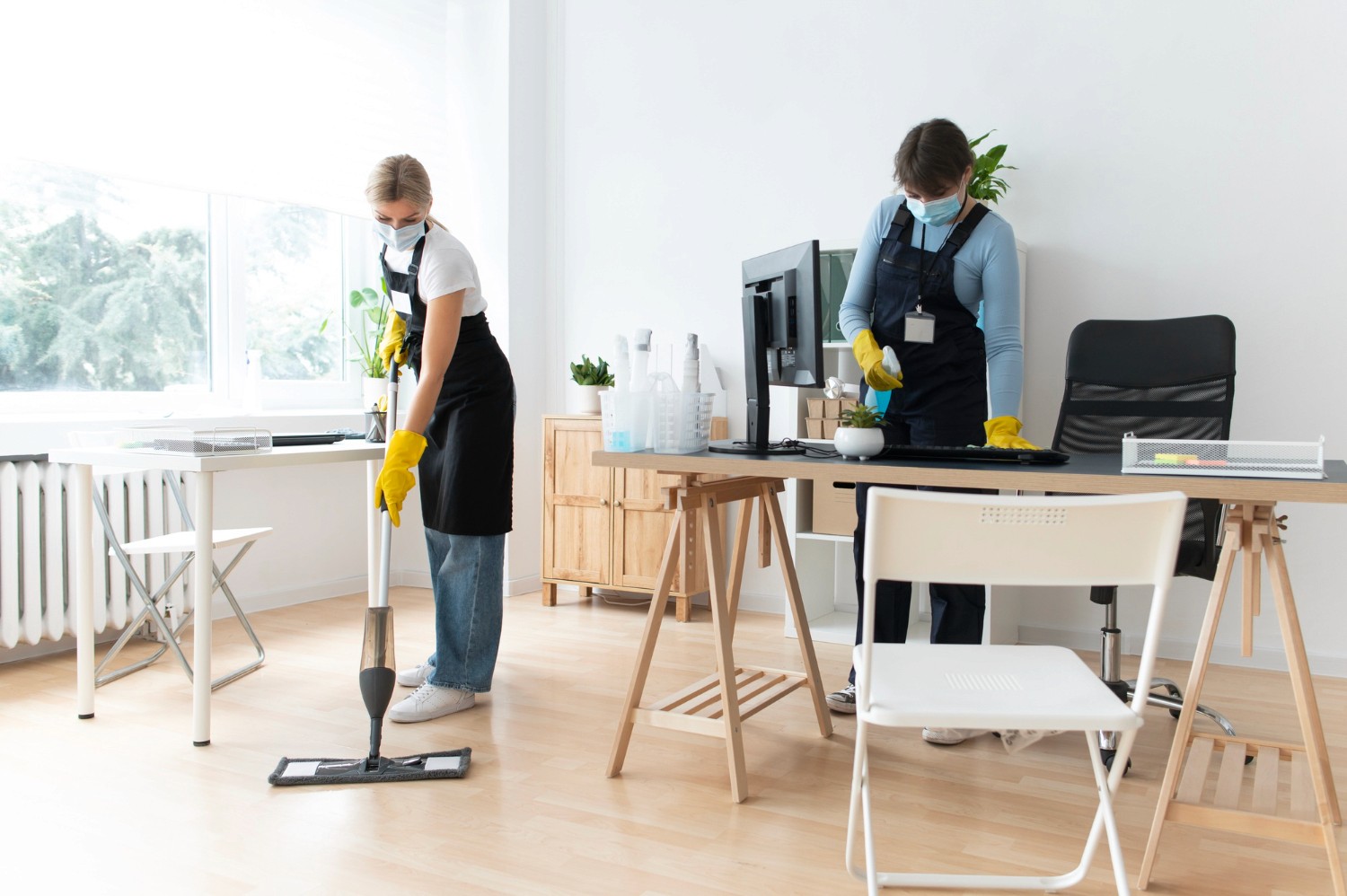 Person cleaning the floor with a green microfiber mop, wearing beige pants and sneakers, showcasing a modern and efficient cleaning method in an office setting.