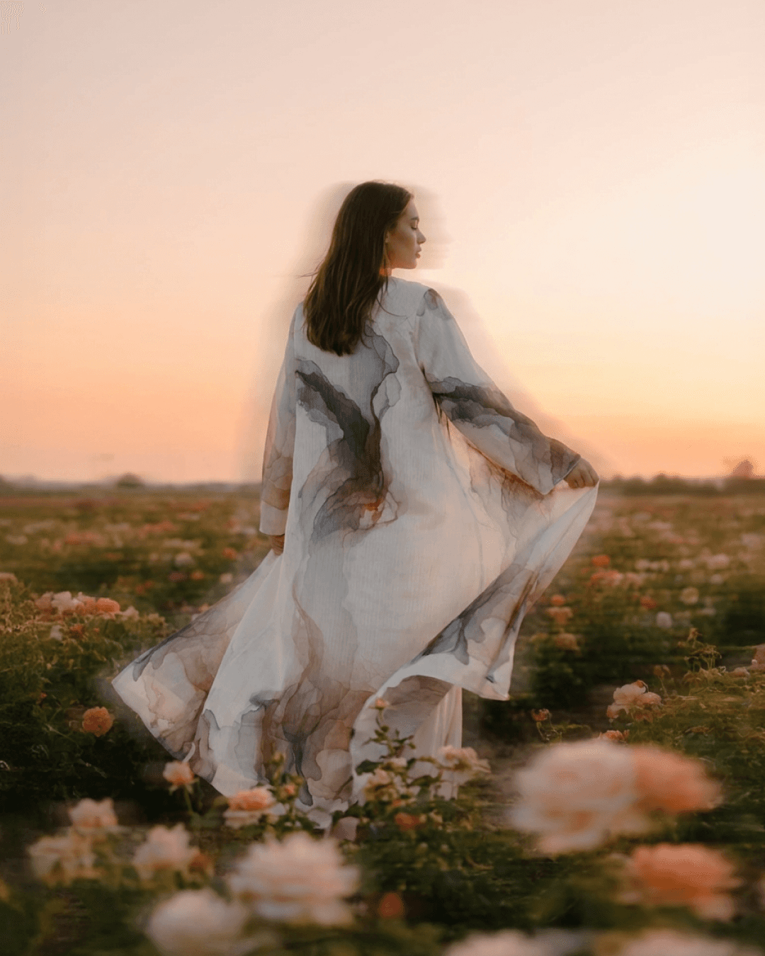 A close-up of a hand wearing multiple decorative rings against a blue background.