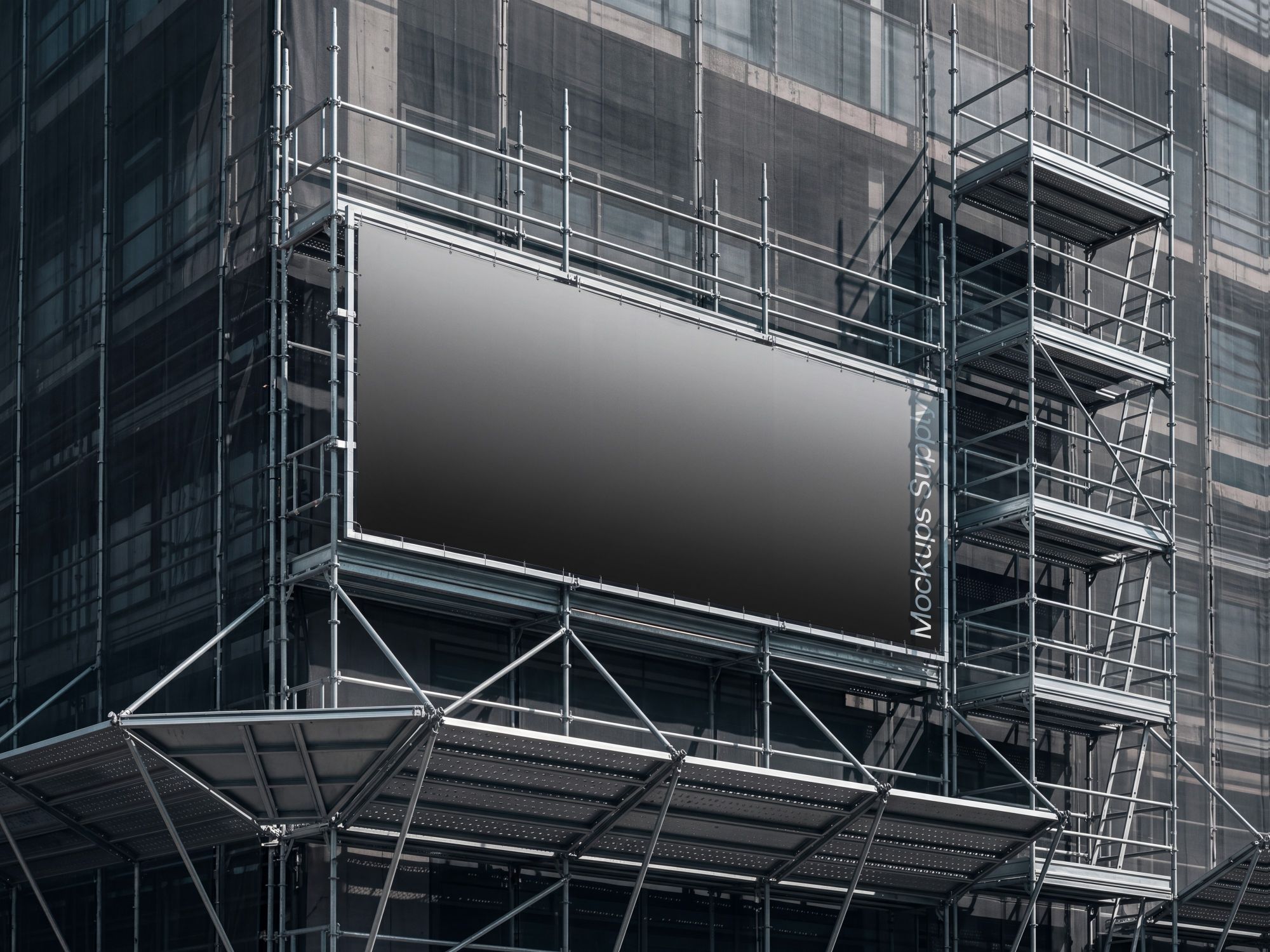 Wide construction banner displayed within silver scaffolding on the exterior of a building