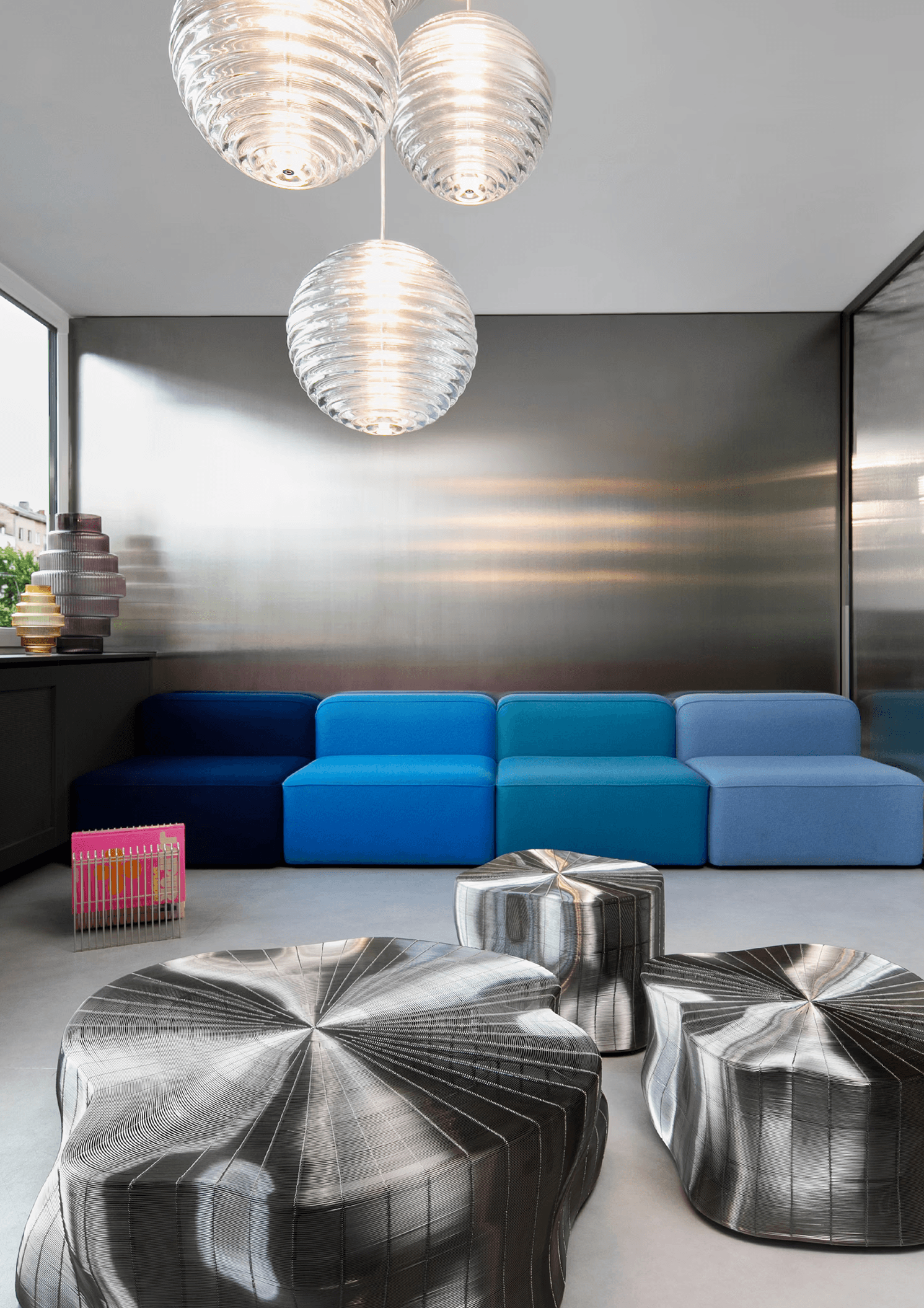 Close-up of hands holding a small glass bottle with a liquid skincare product, against a soft, blurred background