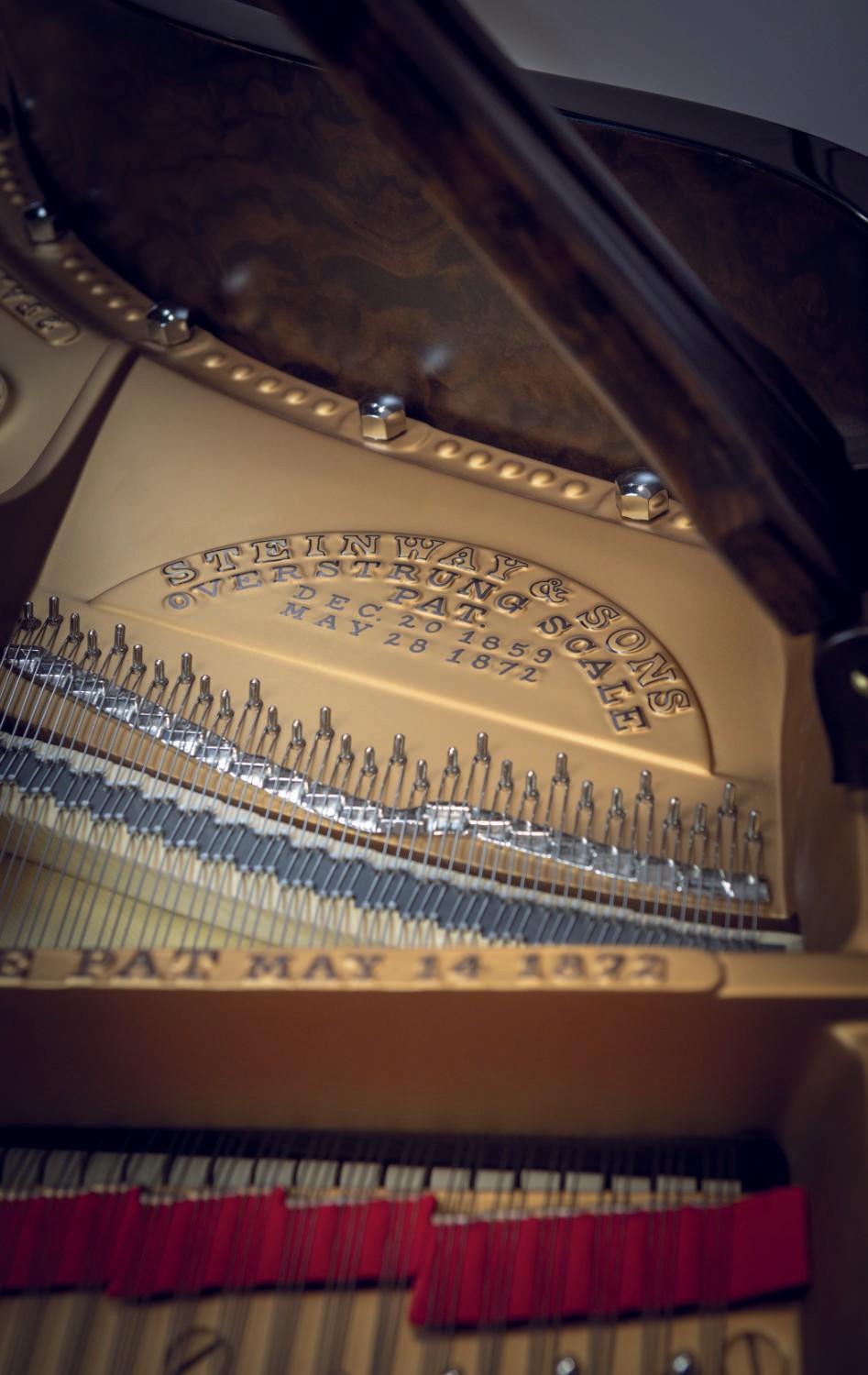 A beautifully restored Steinway & Sons piano with a black polyester finish and burl walnut elements in a classic cabinet.