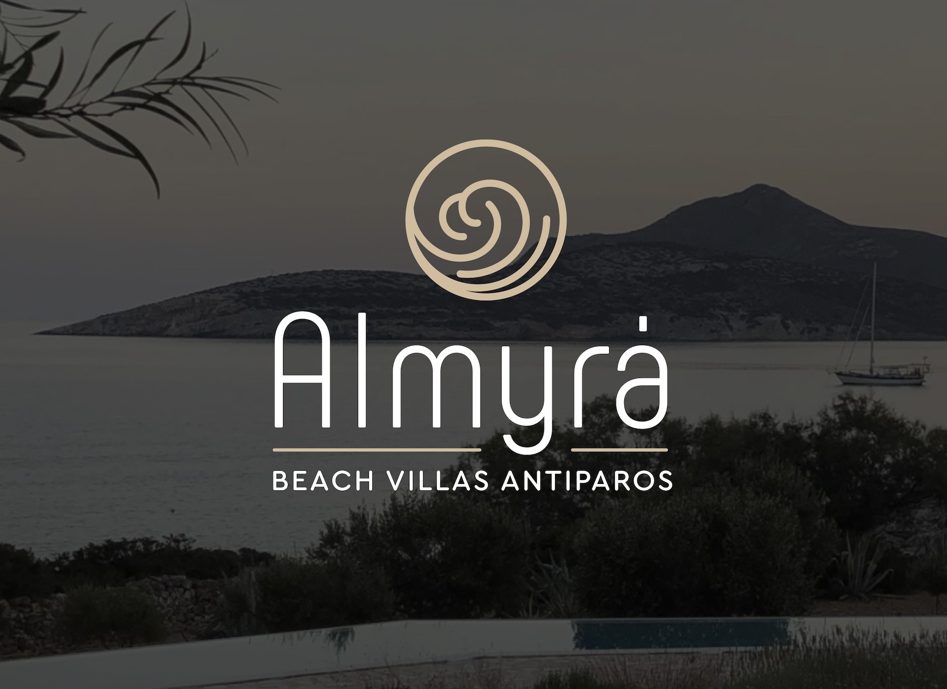 Almyra Beach Villas Antiparos logo over scenic coastal view from Antiparos