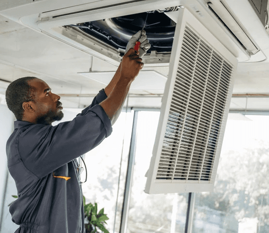 HVAC technician performing professional duct cleaning in a Toronto home to improve airflow, remove dust buildup, and enhance indoor air quality.