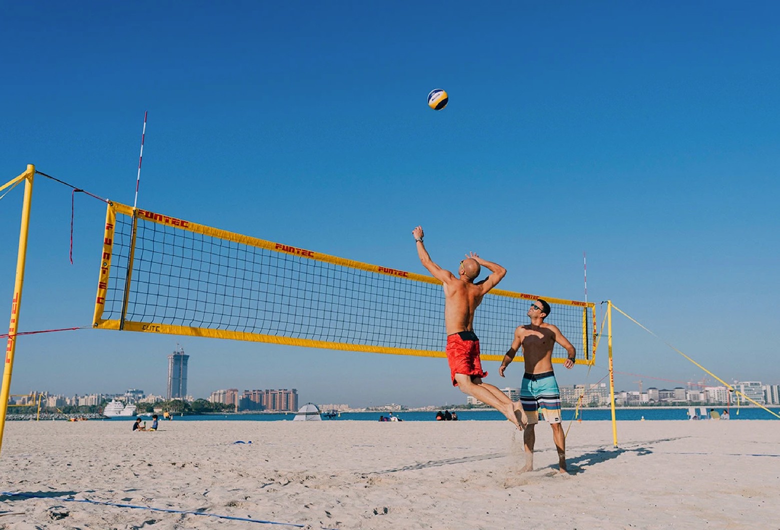 Two Volleyball players practicing striking