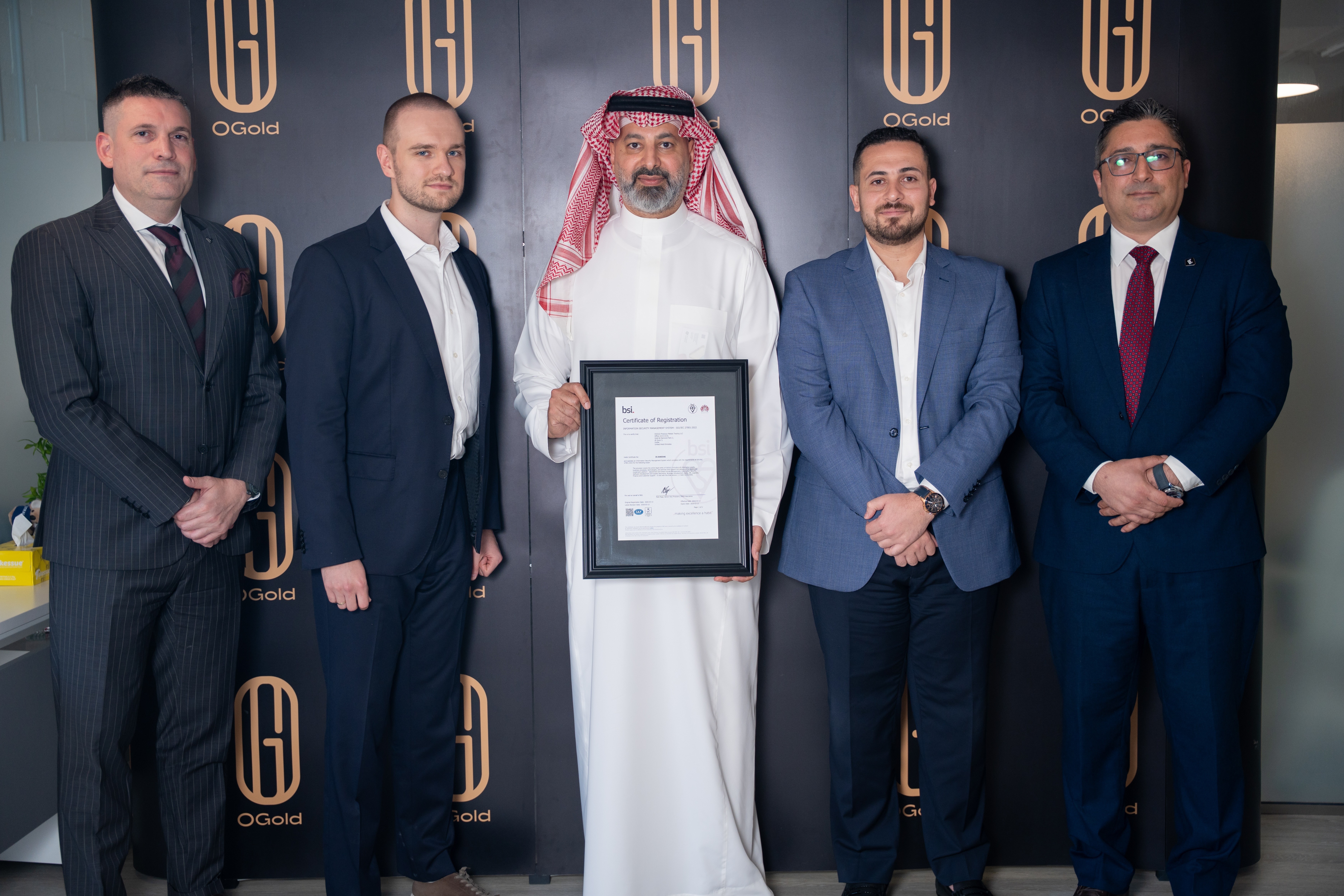 OGold ISO 27001:2022 certificate of registration from BSI Group, presented at the certification ceremony alongside Dynova's vCISO