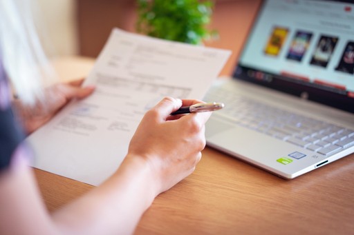 Woman signing a piece of paper
