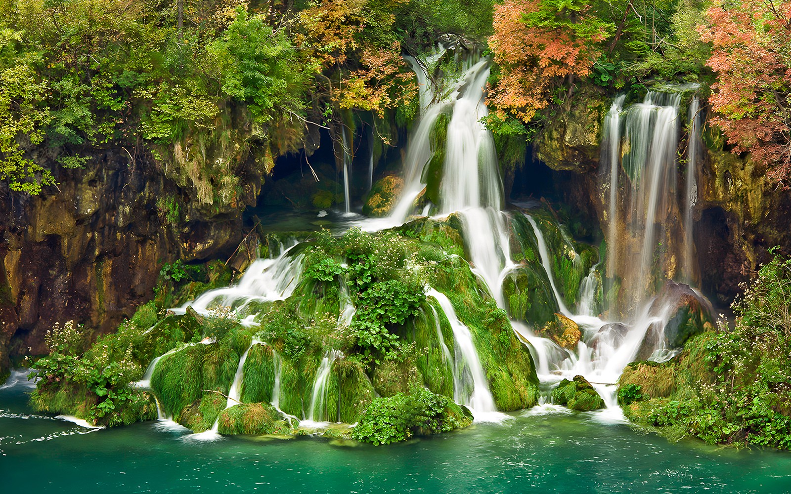 Waterfalls cascading over mossy rocks at Plitvice Lakes National Park, Croatia.