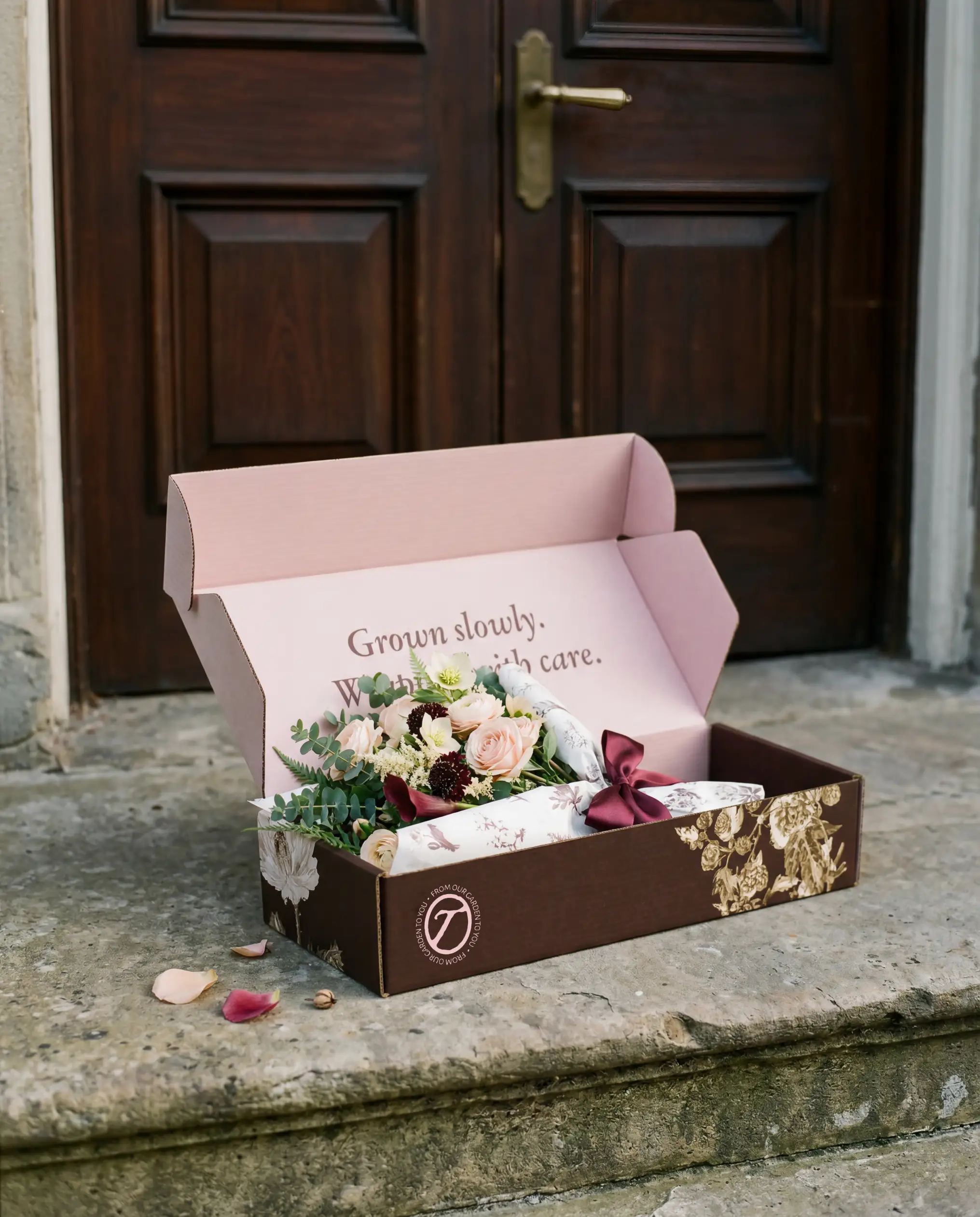 Tended brand identity — branded mailer box with bouquet inside on doorstep