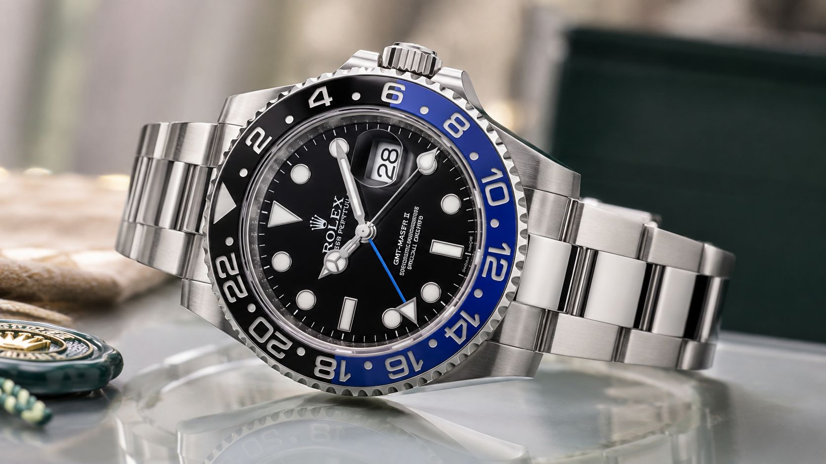 A professional studio shot of a Rolex GMT-Master II watch with a black and blue bezel.