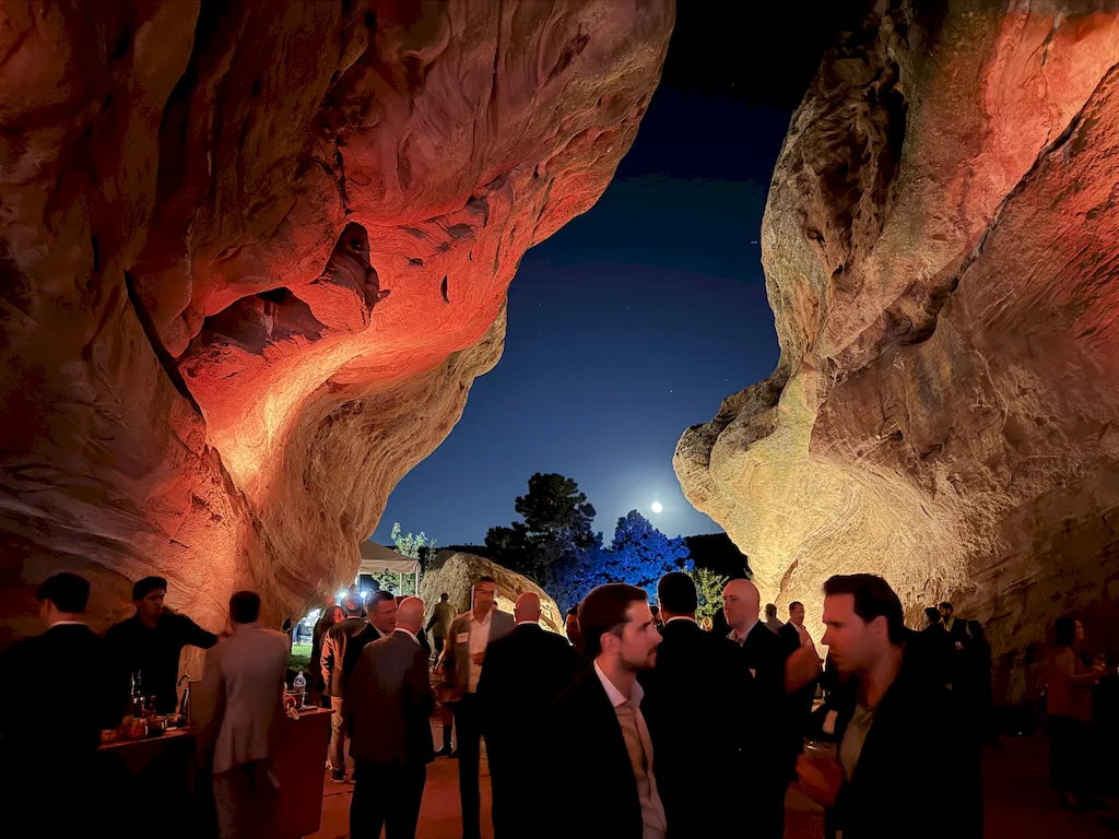 Beautiful night shot of people hanging out at an event in a cave
