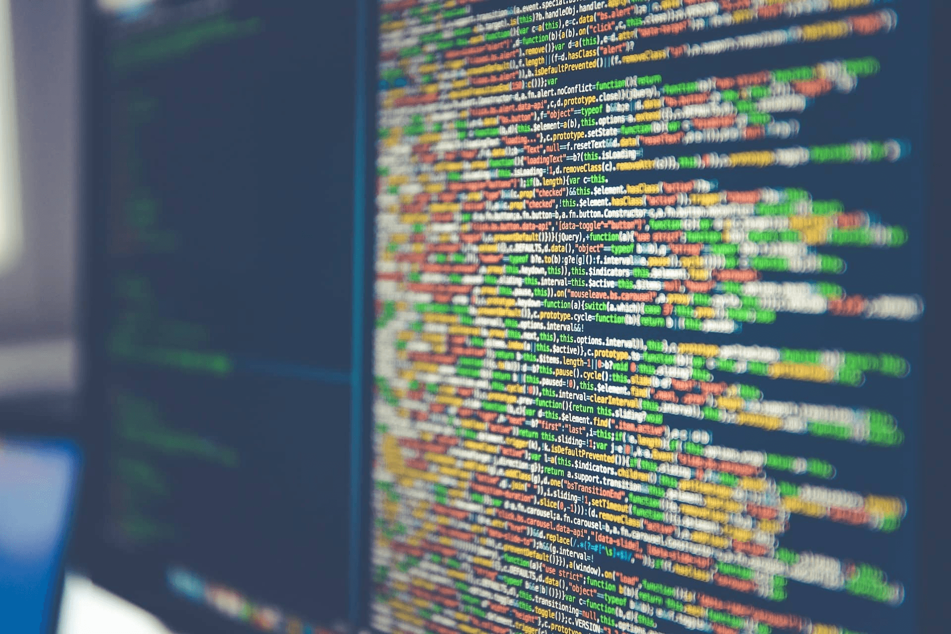 Computer screen filled with colorful codes - Varonis Alternatives