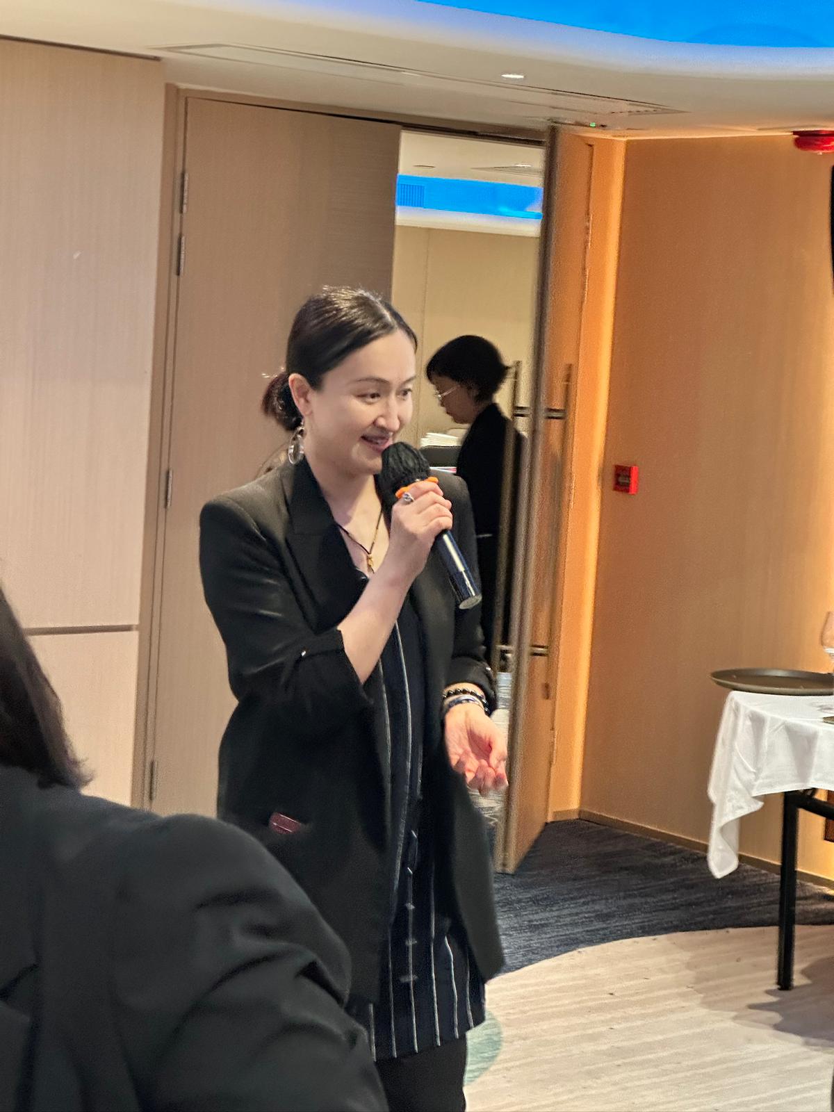 Angela Wai - Professional WSET-certified sommelier pouring wine at a corporate event, providing expert guidance and tasting notes