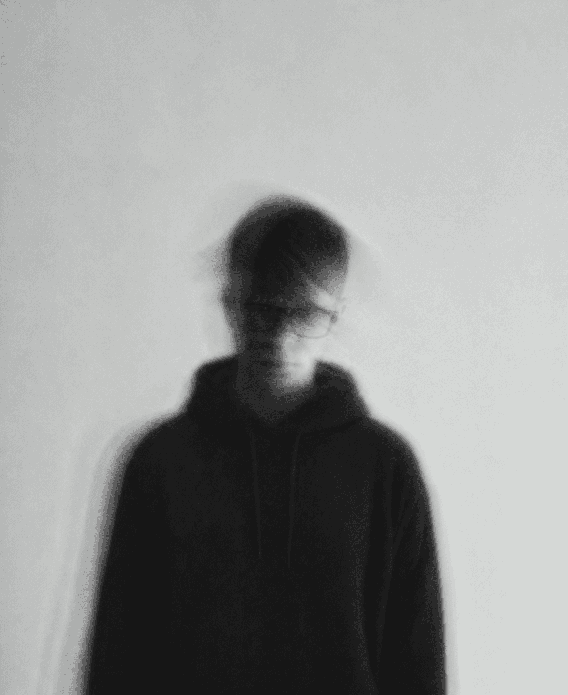 a blurry photo of a person standing in front of a wall