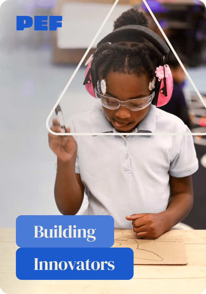 Young, elementary students holding a marker, working on a project in a school fabrication lab. 