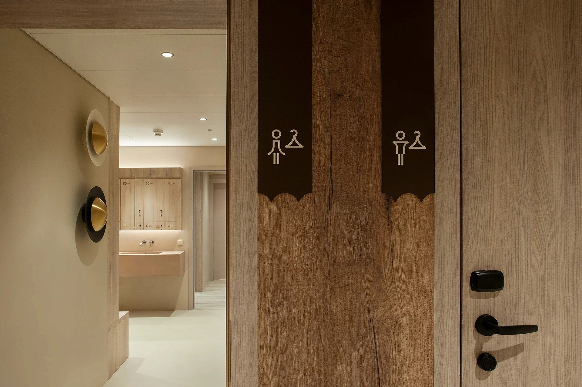 Directional graphics for rooms, restaurant and conference rooms applied to a bronze wall panel overlooking a hotel restaurant
