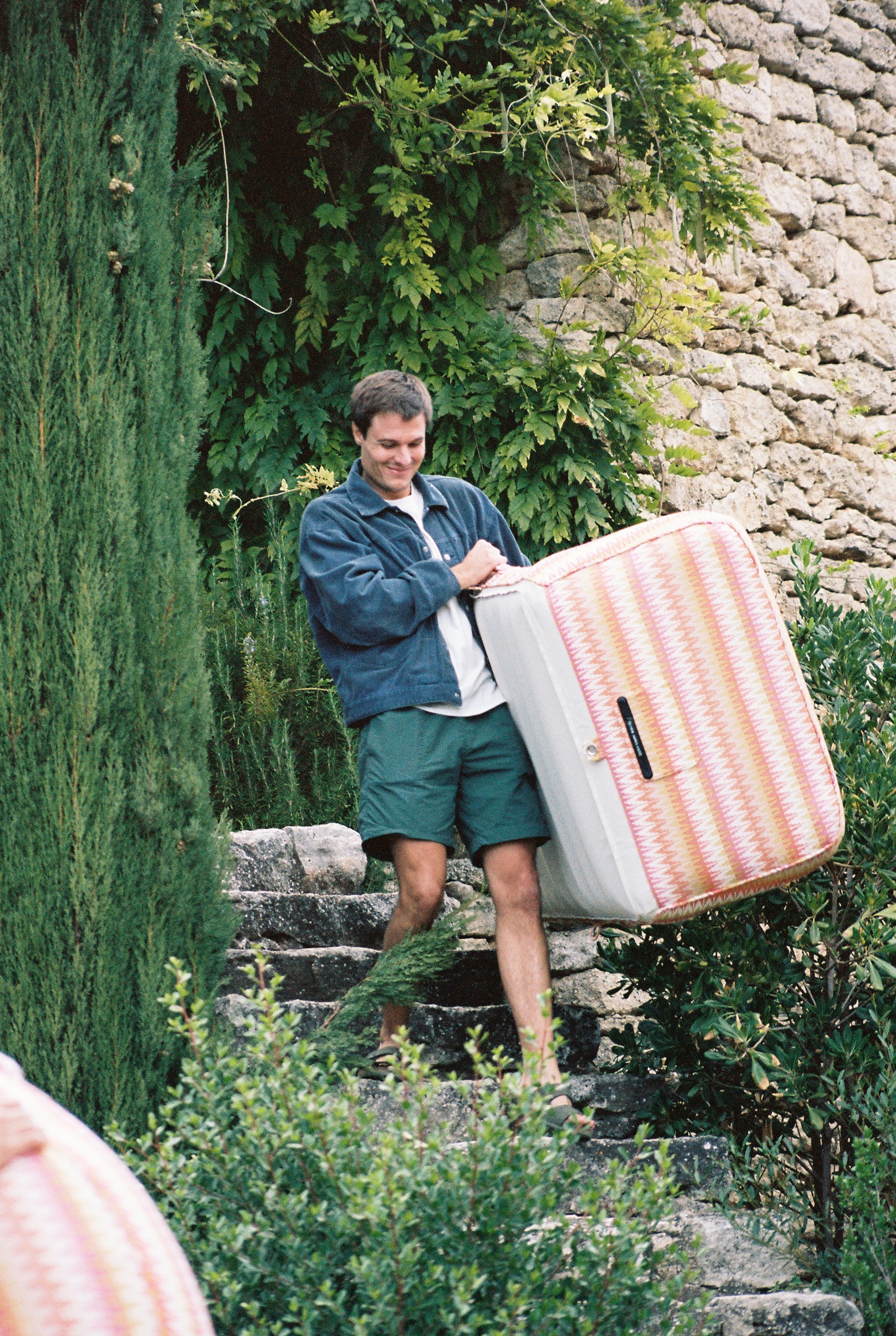 Oliver, founder, happily  carrying colorful matress.