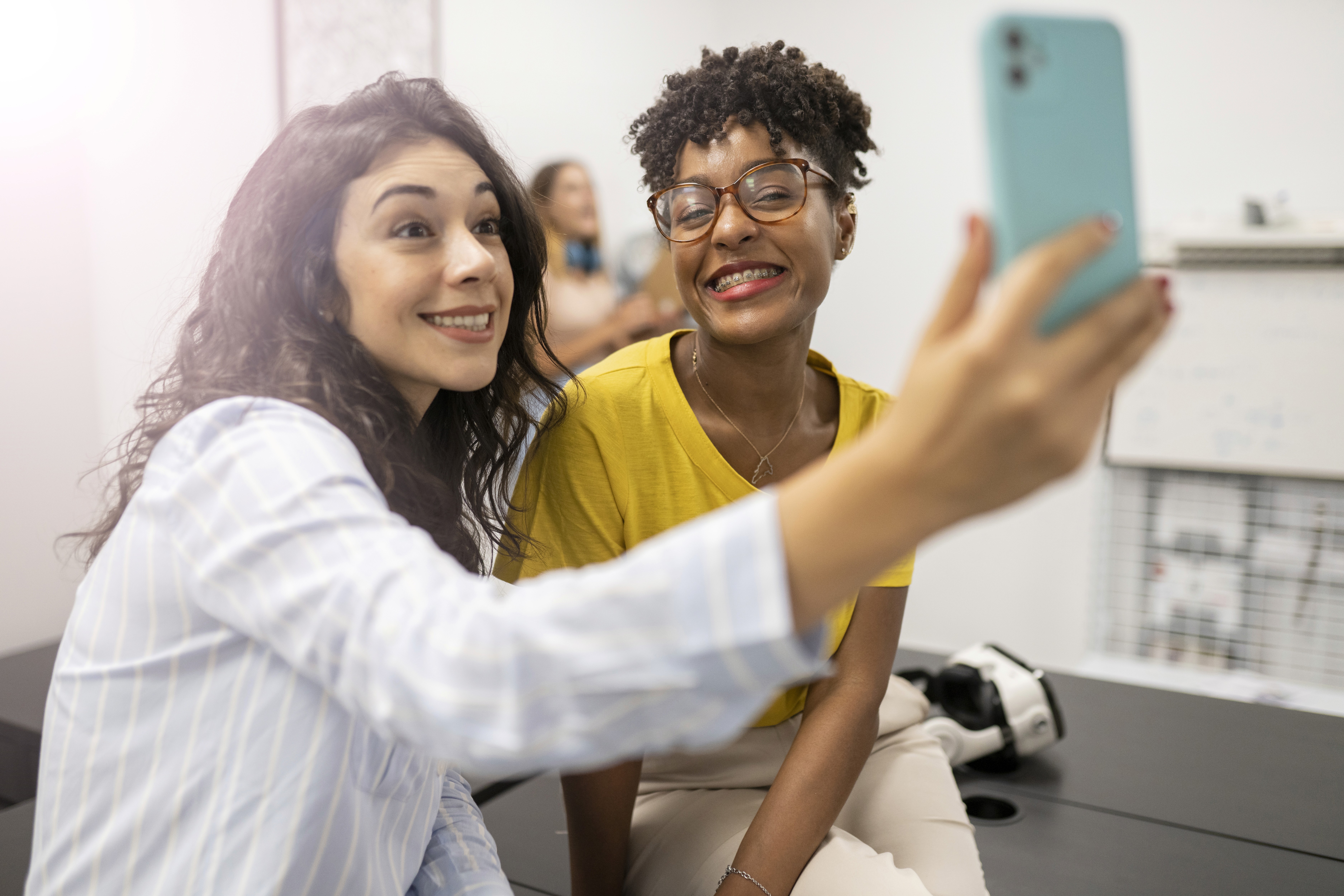 two-women-taking-selfie-in-the-office