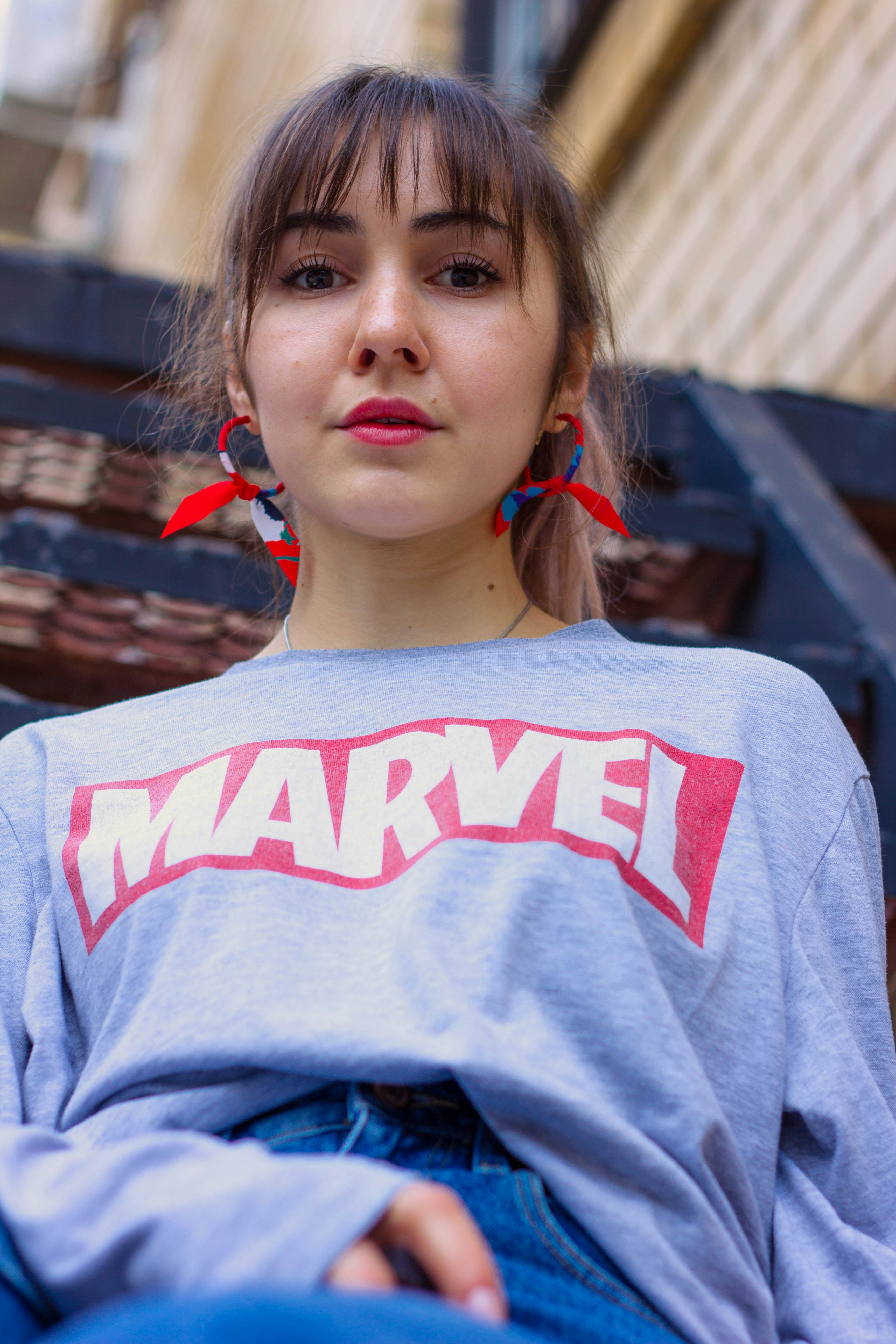 woman wearing blue Marvel sweater