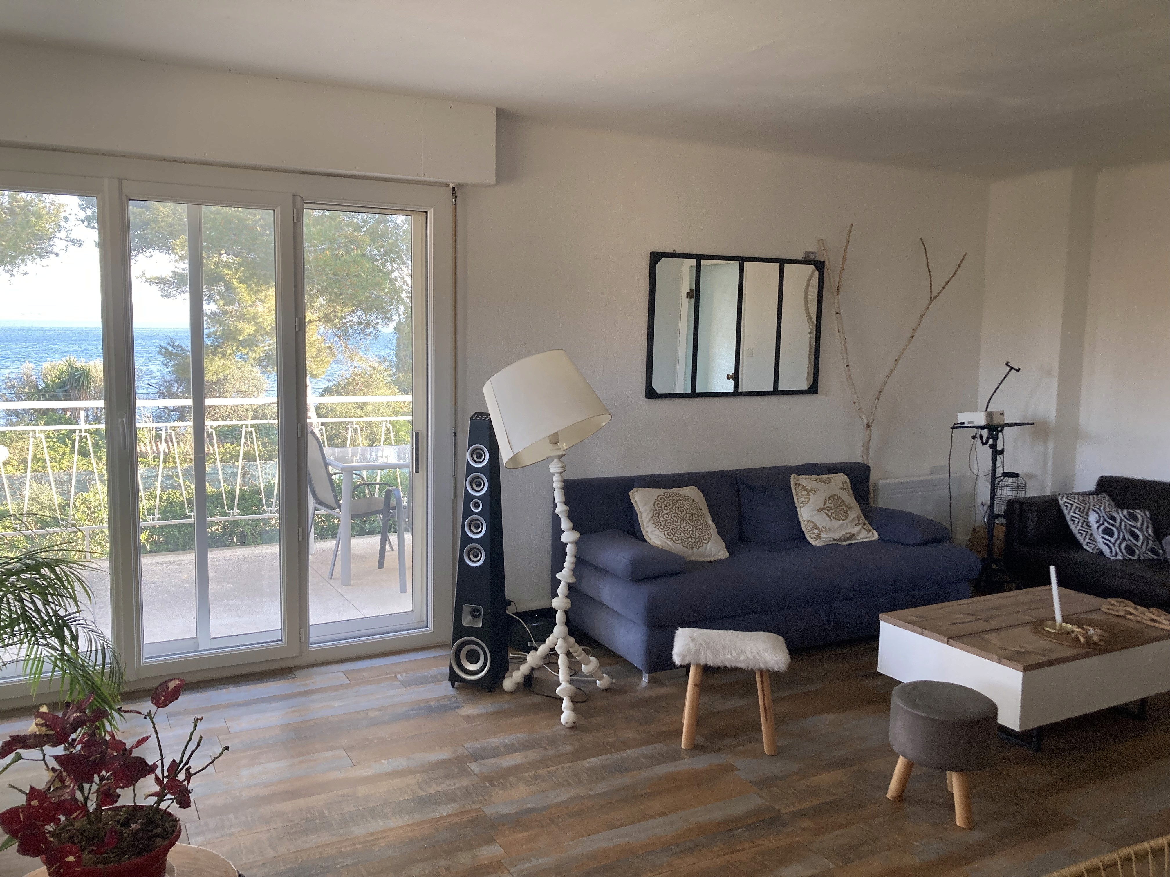 Dramatic sunset over a rocky coastline with ocean waves.