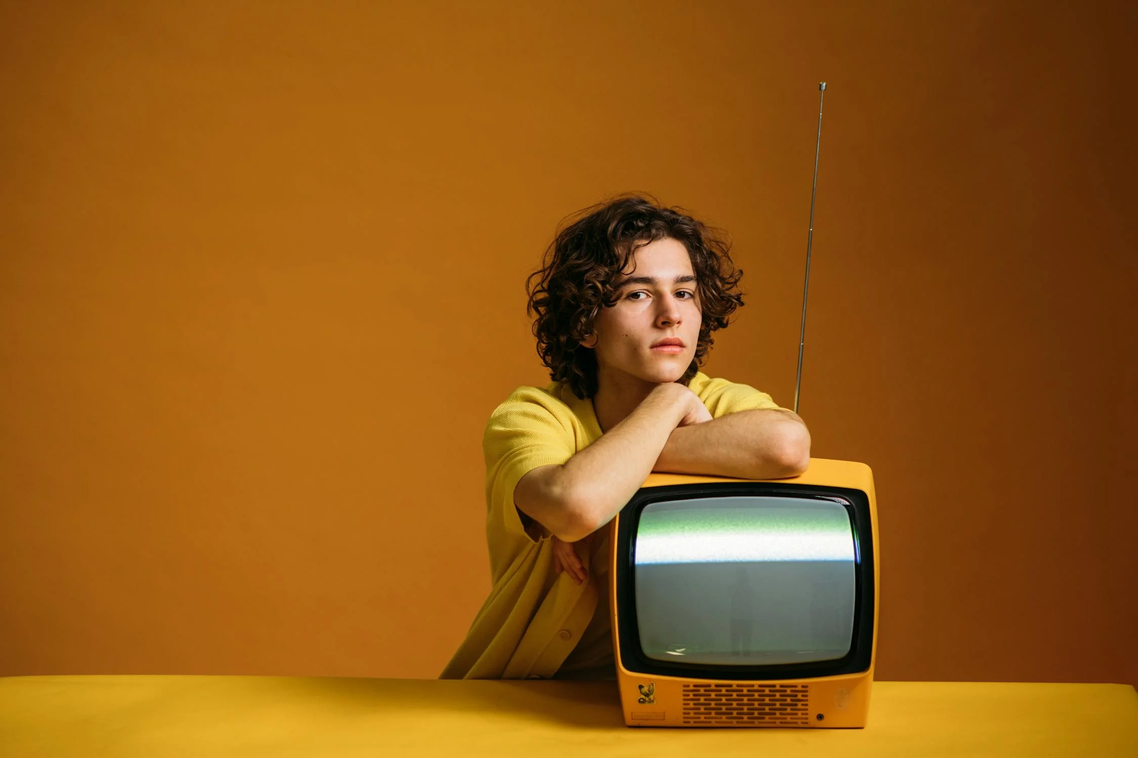 Man Leaning On TV