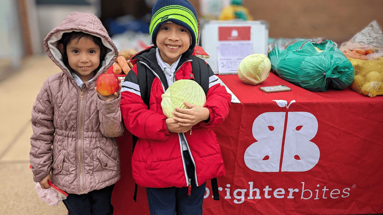 Two people talking at table in plant-filled café