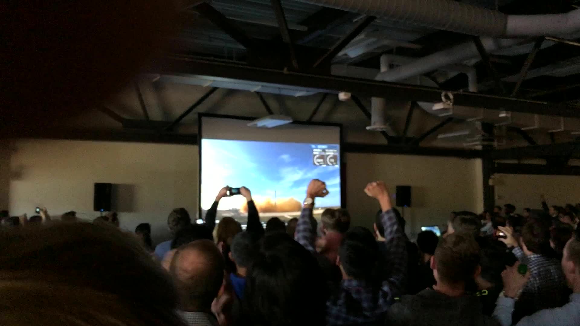 Tesla engineers watching the Falcon Heavy launch from the lobby
