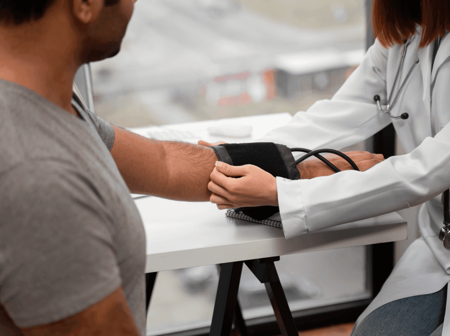 A doctor measuring a man's blood pressure