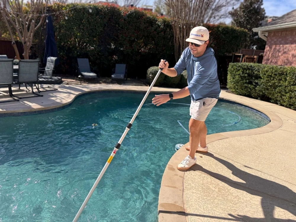 Plano pool being cleaned by technician from Poolside, TX pool service