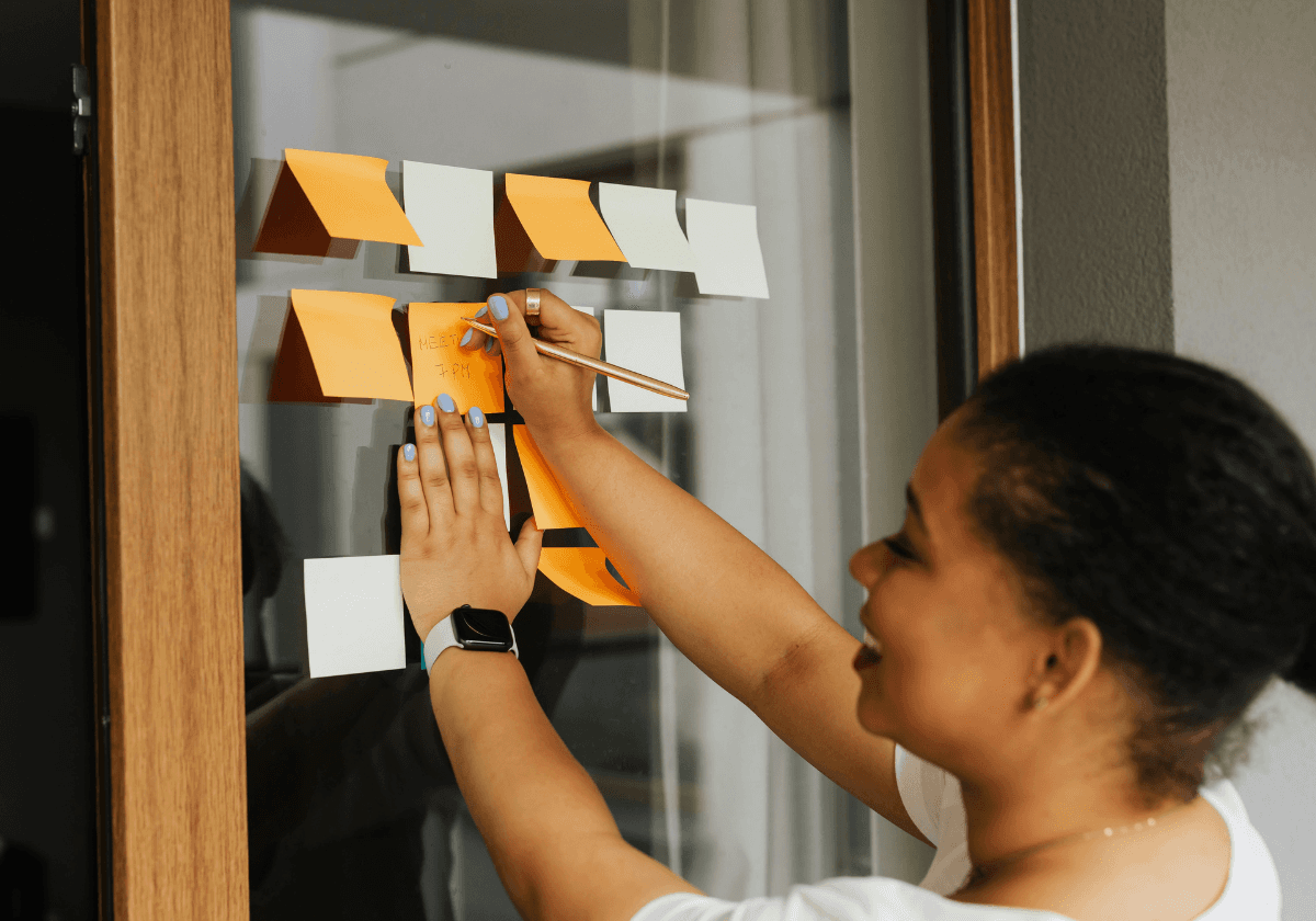 Aerial view of a winding road cutting through rocky terrain with patches of grass.