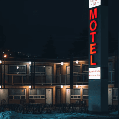 A night view of a motel symbolizing truckers' rest for safer journeys.